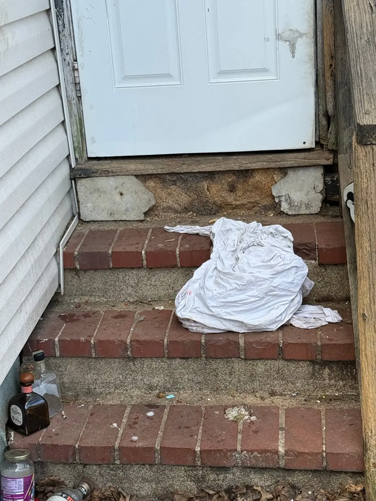 Trying to stop a foreclosure in Hempstead: crumbling brick back steps with the mortar falling out