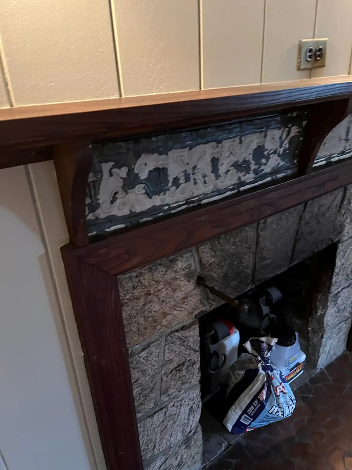 Selling a fire-damaged house in Hempstead: old fireplace with peeling paint above the opening