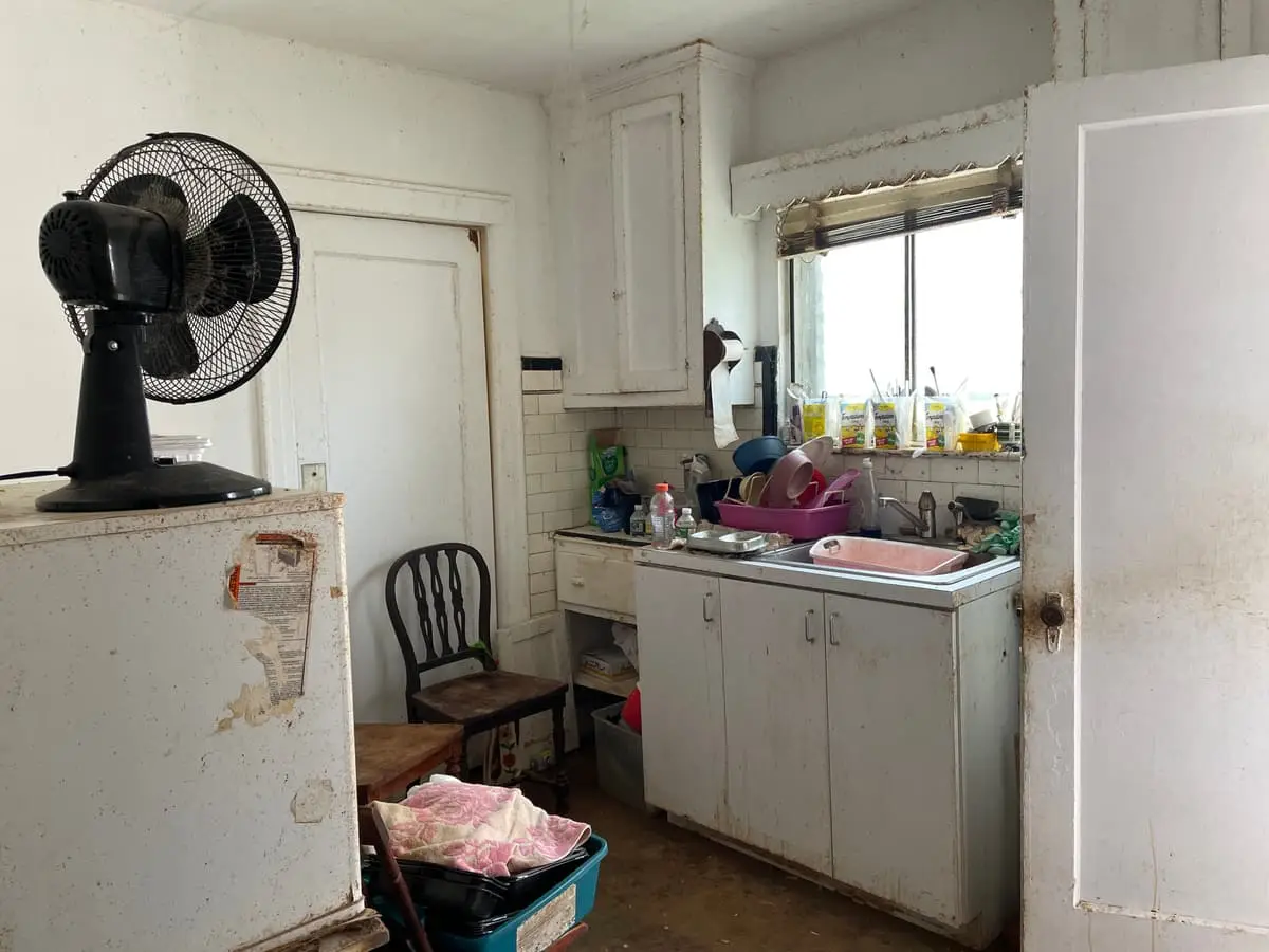 Selling estate property as an executor in Hempstead: small dated kitchen with a pink sink and cluttered counters